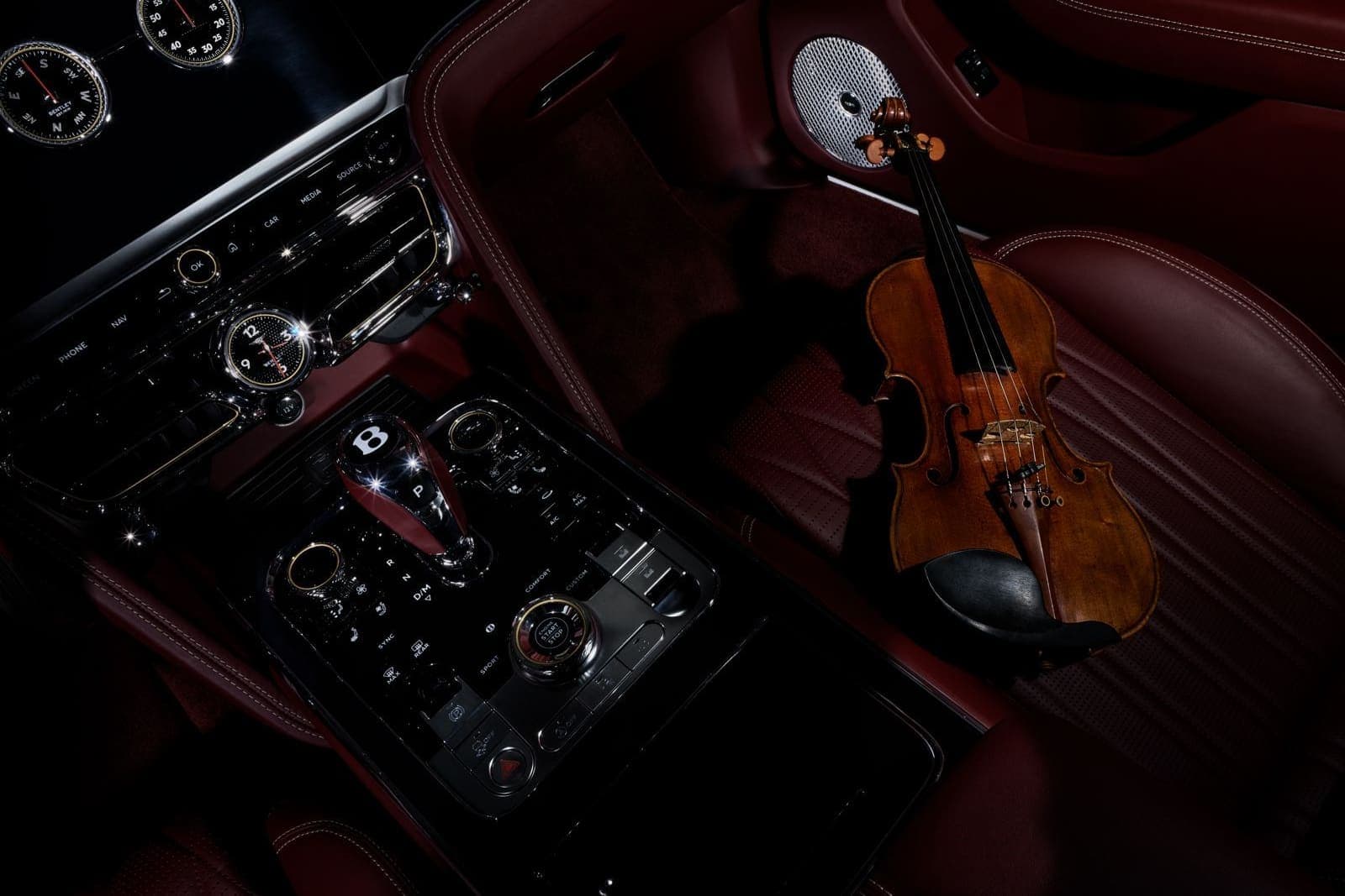 From the work of Andrea Belluso — a violin resting in a car interior